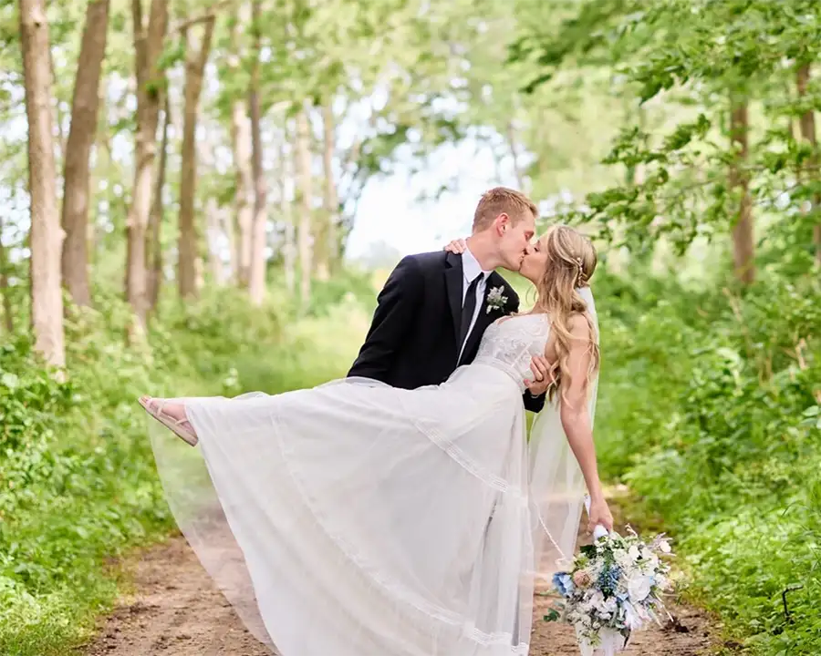 Paul's Paradise - bride and groom kissing and embracing, posing for wedding photo shoot on Tree Farm - Pleasant Plains, IL