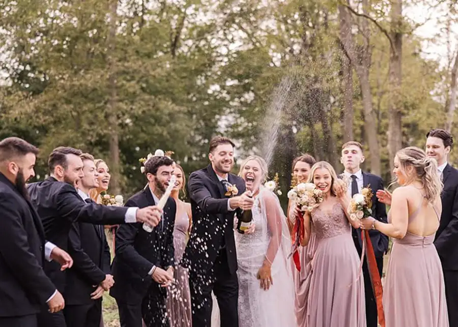 Paul's Paradise - wedding party celebrating outside with champagne - Pleasant Plains, IL