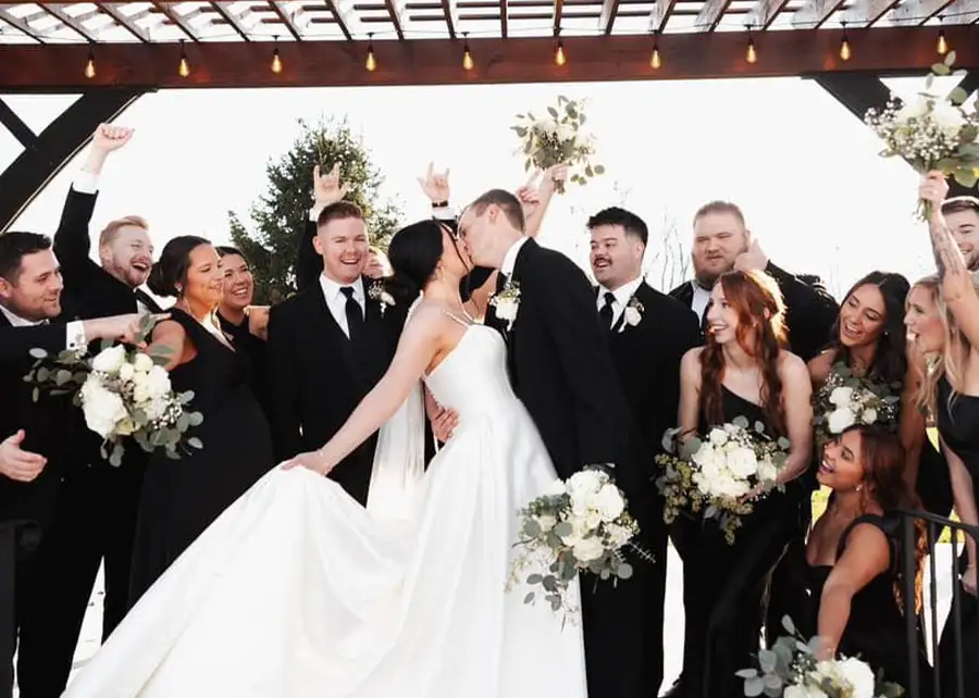 Paul's Paradise - Wedding Party cheers and celebrates as bride and groom kiss at their outdoor wedding ceremony - Pleasant Plains, IL